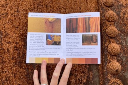 A open booklet displayed on an industrial metal surface