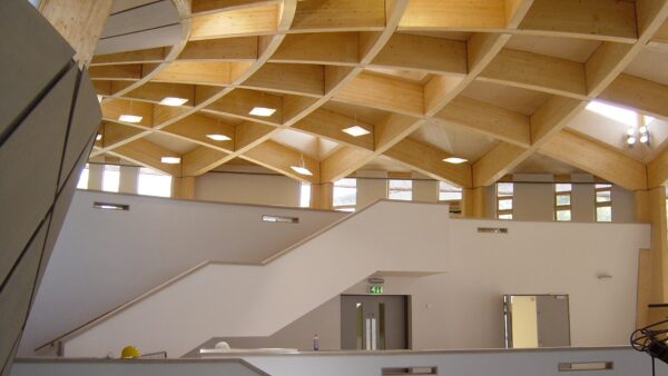Construction of the Core building at the Eden Project with acoustic baffle panels in ceiling