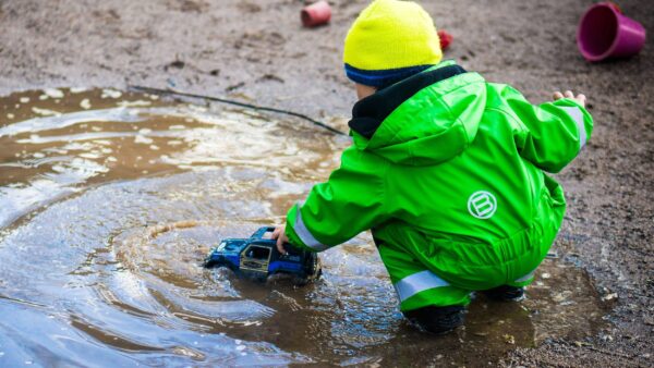Young child having fun with a puddle