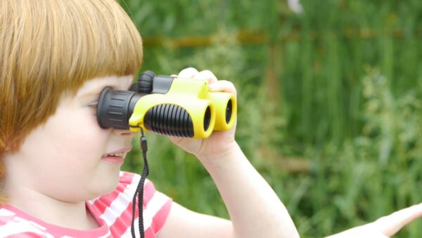 Young girl looking through binoculars