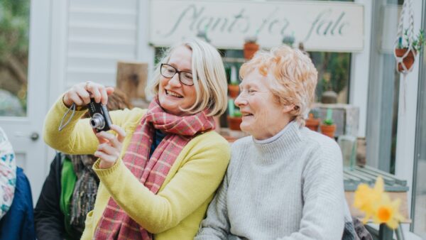 Two women taking photos together