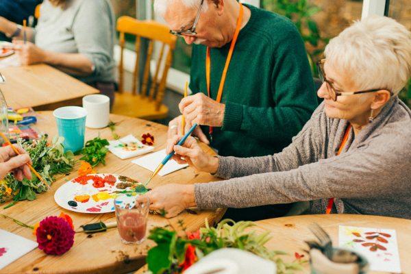 Older people enjoying creative nature activities indoors