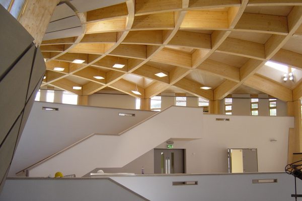 Construction of the Core building at the Eden Project with acoustic baffle panels in ceiling
