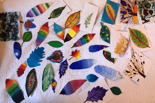 Hand painted leaves spread out on a white background