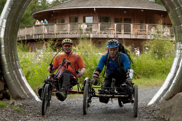 Two cyclists using wheelchair-adapted bikes