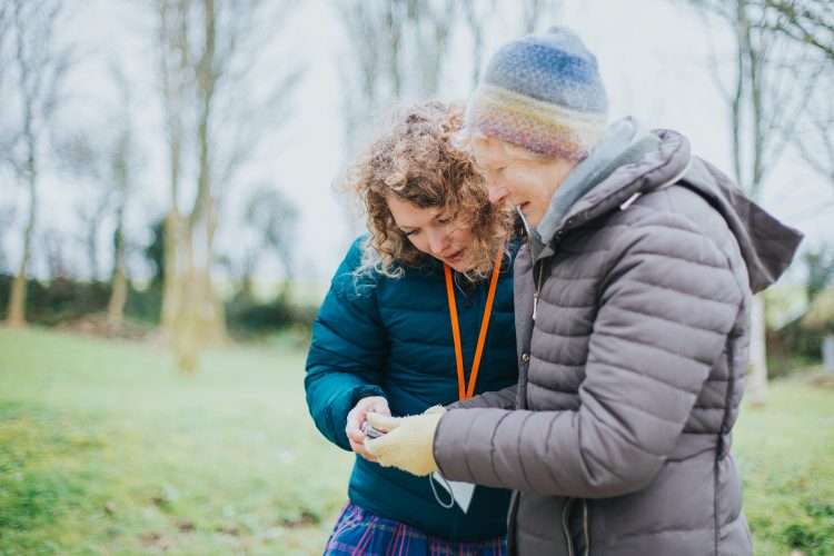 Sensory Trust activity group member and staff doing a nature activity