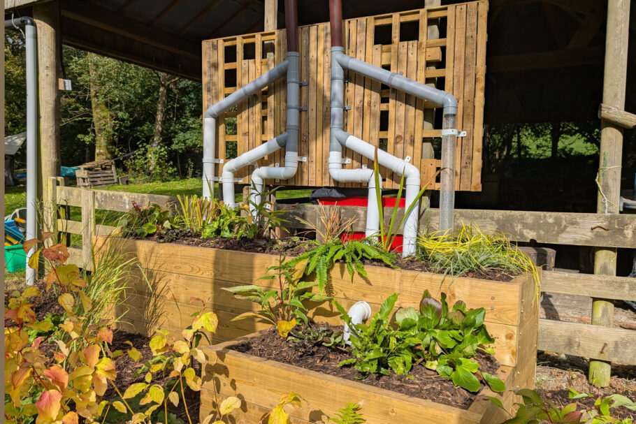 A creative pattern of guttering and raised planters in a mini rain and sponge garden